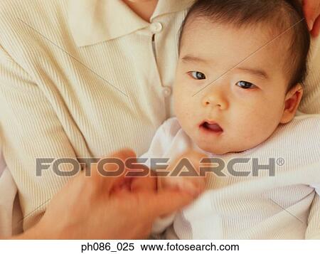 Mother holding infant, portrait View Large Photo Image Stock Photography - Mother holding infant, portrait . Fotosearch