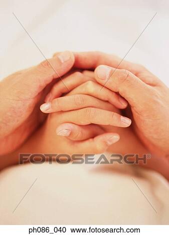 Stock Image - Mother holds her daughter's small hand. . Fotosearch