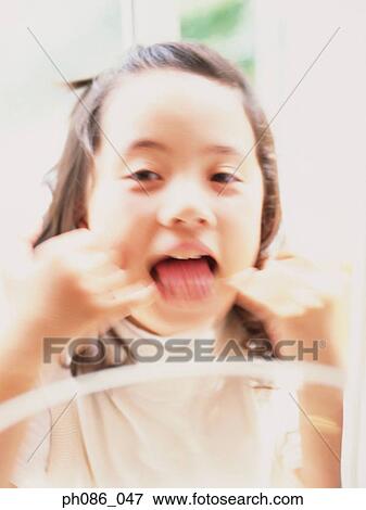 Stock Photo - Portrait of a girl mouth open. Fotosearch