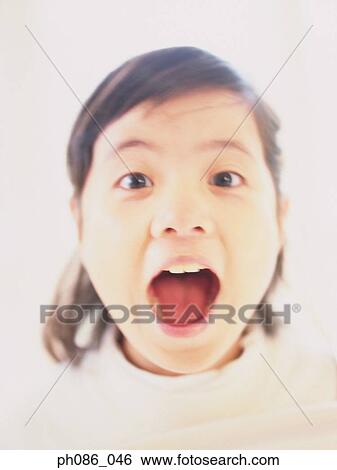 Portrait of a young girl looking surprised View Large Photo Image Stock Photograph - Portrait of a young girl looking surprised . Fotosearch
