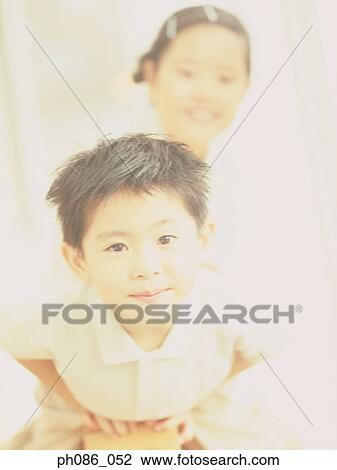 Stock Image - Portrait of brother and sister. Fotosearch