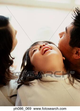 Stock Photo - Portrait of father, mother and daughter. Fotosearch