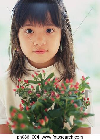 Portrait of girl holding flowers View Large Photo Image Picture - Portrait of girl holding flowers. Fotosearch