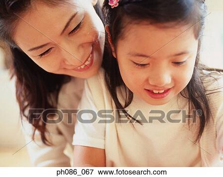 Stock Photo - Portrait of mother and daughter. Fotosearch