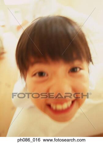 Portrait of young girl smiling, close-up View Large Photo Image Stock Photograph - Portrait of young girl smiling, close-up. Fotosearch