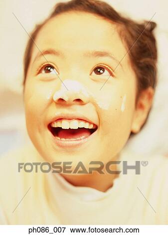 Young girl smiling with powder on nose, close-up View Large Photo Image Stock Photo - Young girl smiling with powder on nose, close-up. Fotosearch