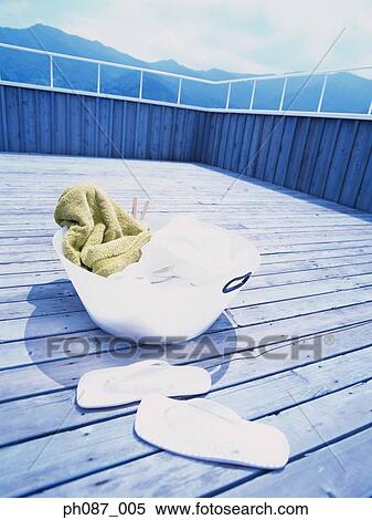 A basket of laundry and a pair of slippers View Large Photo Image Stock Photography - A basket of laundry and a pair of slippers. Fotosearch