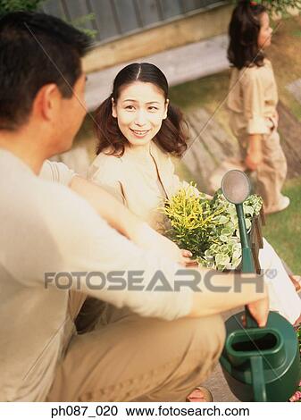 Family in the garden View Large Photo Image Stock Image - Family in the garden. Fotosearch