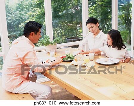 Family of three eating breakfast View Large Photo Image Stock Image - Family of three eating breakfast. Fotosearch