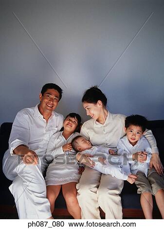 Stock Image - Family watching television program. Fotosearch