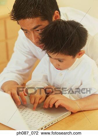 Father and son using laptop computer View Large Photo Image Stock Image - Father and son using laptop computer . Fotosearch
