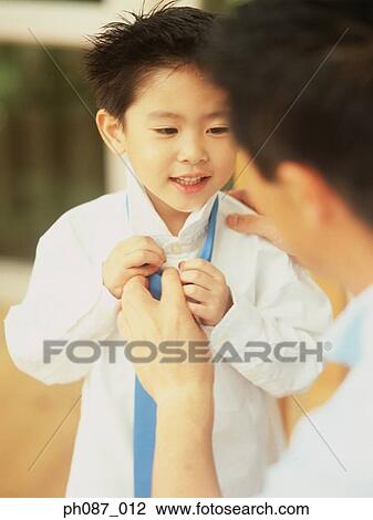 Father tying tie for son, close-up View Large Photo Image Stock Image - Father tying tie for son, close-up. Fotosearch