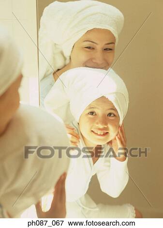 Mother and daughter wearing towel wrapped on head View Large Photo Image Stock Photo - Mother and daughter wearing towel wrapped on head . Fotosearch