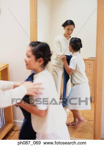 Stock Photo - Mother dressing up laugher. Fotosearch