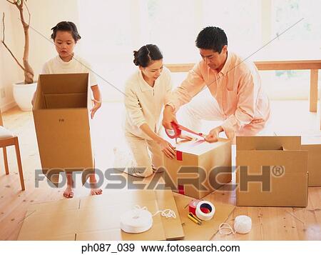 Parents and daughter packing boxes View Large Photo Image Stock Photo - Parents and daughter packing boxes. Fotosearch