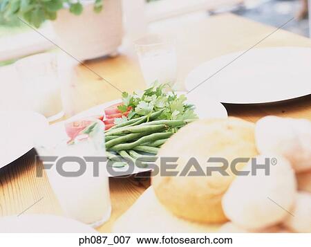 Pastry, greens and glasses of water on table View Large Photo Image Stock Photo - Pastry, greens and glasses of water on table. Fotosearch