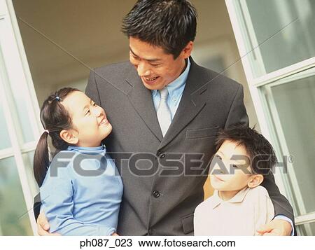 Stock Image - Portrait of father and children. Fotosearch
