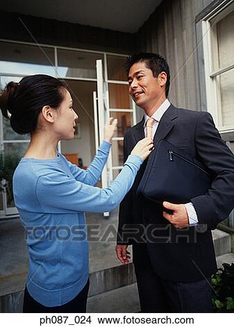 Picture - Wife adjusting husband's tie. Fotosearch