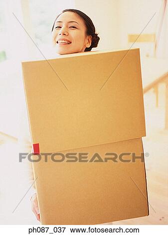 Woman carrying 2 carton boxes View Large Photo Image Stock Photo - Woman carrying 2 carton boxes. Fotosearch