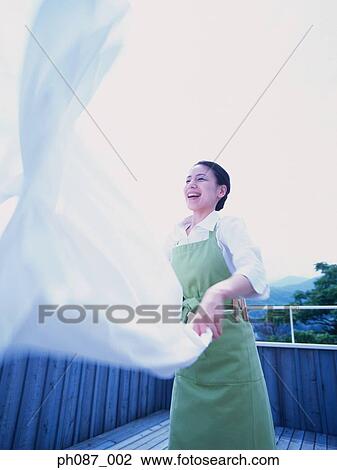 Woman shaking bed sheet View Large Photo Image Stock Image - Woman shaking bed sheet. Fotosearch