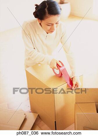 Woman taping carton box View Large Photo Image Stock Photograph - Woman taping carton box. Fotosearch