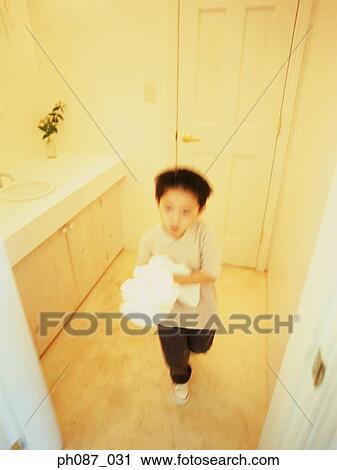 Young boy walking, hands holding a towel View Large Photo Image Stock Image - Young boy walking, hands holding a towel. Fotosearch