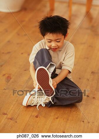 Young boy wearing shoes View Large Photo Image Stock Photograph - Young boy wearing shoes. Fotosearch