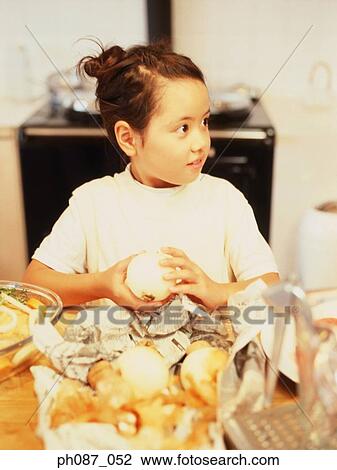Young girl peeling onion View Large Photo Image Stock Image - Young girl peeling onion. Fotosearch