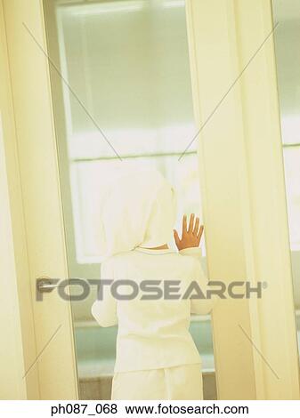 Young girl wearing towel wrapped on head, standing at the door View Large Photo Image Stock Photo - Young girl wearing towel wrapped on head, standing at the door . Fotosearch