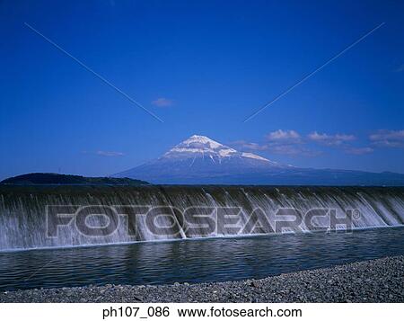 Stock Photograph - Dam, Mt. Fuji, Japan in background. Fotosearch