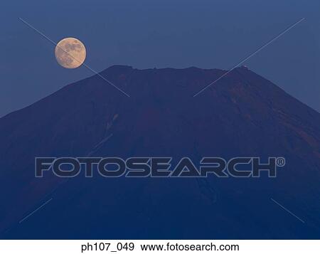 Stock Photo - Moon at peak of Mt. Fuji, Japan. Fotosearch