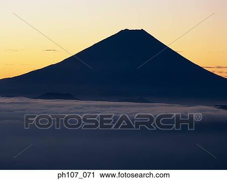 Stock Image - Silhouette of Mt. Fuji, Japan at sunset. Fotosearch