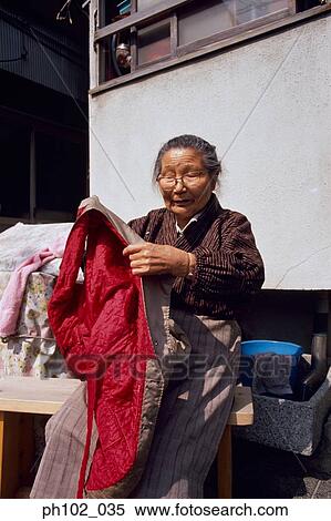 Stock Photography - Matured Japanese woman doing laundry. Fotosearch