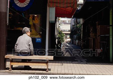Matured Japanese woman sitting on a bench, rear view View Large Photo Image Stock Photo - Matured Japanese woman sitting on a bench, rear view. Fotosearch