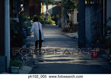 Stock Photography - Matured Japanese woman washing the alley. Fotosearch