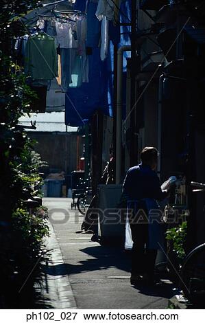 Woman in a small alley View Large Photo Image Stock Photo - Woman in a small alley. Fotosearch