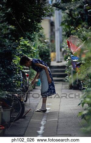 Woman in a small alley View Large Photo Image Stock Photograph - Woman in a small alley. Fotosearch