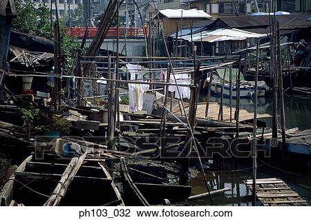 Stock Image - Floating houses along a canal. Fotosearch