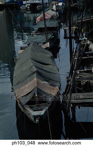Wooden boats dock at the side of a canal View Large Photo Image Stock Photo - Wooden boats dock at the side of a canal. Fotosearch