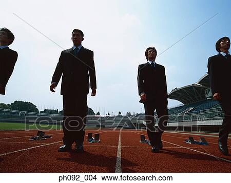 Businessman walking towards starting block View Large Photo Image Picture - Businessman walking towards starting block . Fotosearch