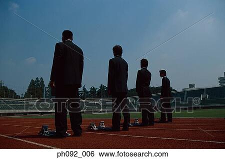 Businessmen getting ready behind starting block View Large Photo Image Stock Photograph - Businessmen getting ready behind starting block. Fotosearch