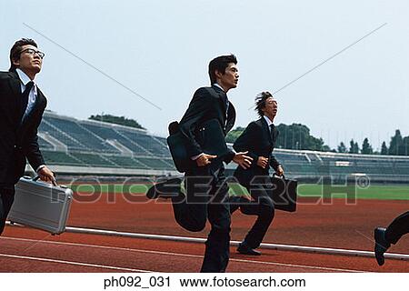 Businessmen running on stadium track, carrying briefcases View Large Photo Image Stock Image - Businessmen running on stadium track, carrying briefcases. Fotosearch