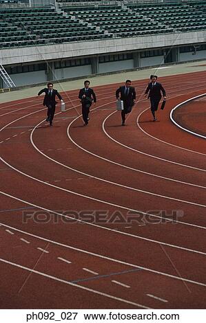 Stock Photo - Businessmen sprinting, carrying briefcases. Fotosearch