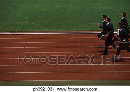 Stock Photo - Businesspeople running on stadium track, carrying briefcases. Fotosearch