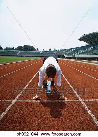 Picture - Businesswoman at starting block . Fotosearch