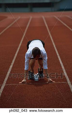 Stock Image - Businesswoman at starting block . Fotosearch