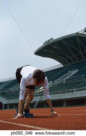 Stock Photo - Businesswoman at starting block . Fotosearch