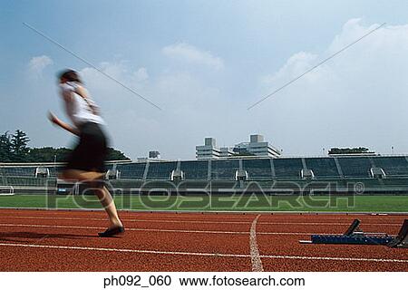 Stock Image - Businesswoman leaving starting block . Fotosearch