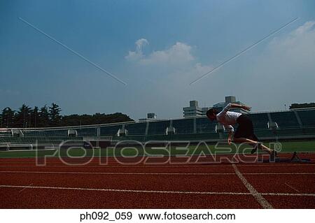Stock Photo - Businesswoman leaving starting block . Fotosearch