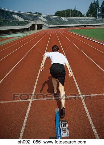 Stock Photograph - Businesswoman leaving starting block . Fotosearch